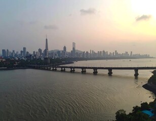 Fototapeta premium City skyline over water at sunset