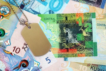 Kuwaiti dinar currency money bills and military token. The concept of army service