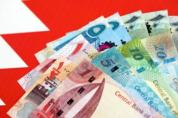 Bahraini dinar currency money bills lies on flag. The concept of business and investment