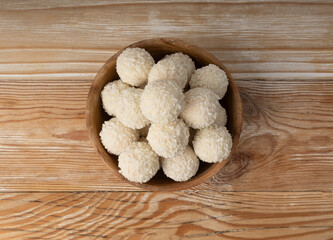 Coconut candies pile, coco ball. White truffle ball, indian ladoo or laddu with sweet cream and coco