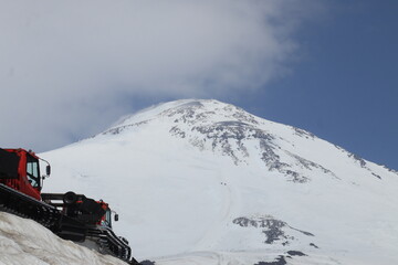 snowcats against the backdrop of Mount Elbrus, early August