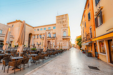 Zadar, Croatia. Old town street of Zadar with the Church of St. Donatus and the bell tower of the Cathedral of St. Anastasia at sunset.