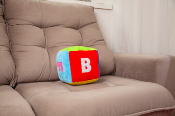 Children's plush dice with the letter B written on them.