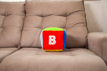 Children's plush dice with the letter B written on them.