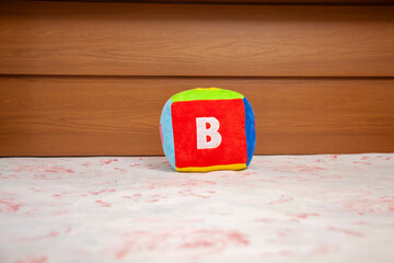 Children's plush dice with the letter B written on them.