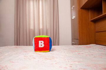Children's plush dice with the letter B written on them.