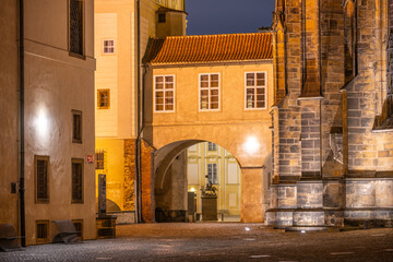 A beautifully illuminated covered bridge at Saint Vitus Cathedral, part of Prague Castle, enhances...
