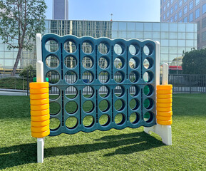 Connect 4 Giant Outdoor Game on Rooftop, with Green Artificial Grass, Turf. Blue-Green with Yellow...