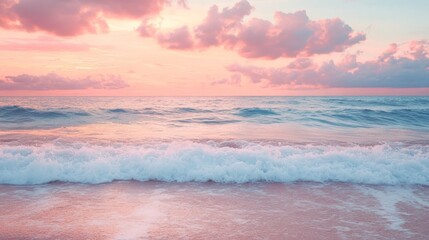 Soft pink sunset illuminating ocean waves, creating a textured beach landscape at dusk