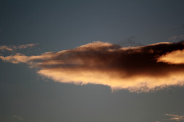 Striking clouds painted with the warm hues of sunset