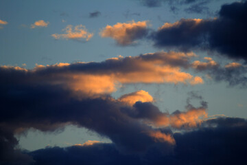 Striking clouds painted with the warm hues of sunset