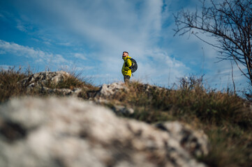 Hiker contemplating nature while standing on mountain top
