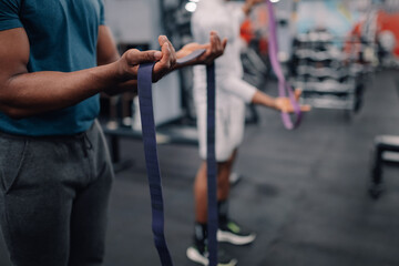 Athletes preparing resistance bands for functional training in gym
