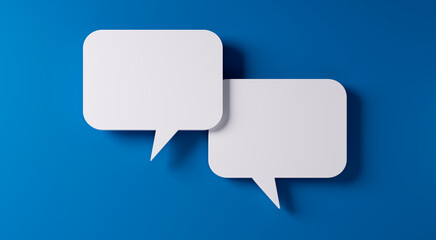 White speech bubbles resting on a blue colored background with copy space - 3D illustration