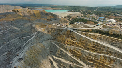 Aerial of open mine and heavy mining equipment