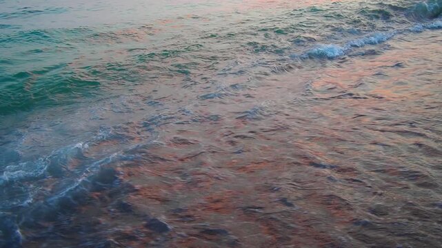 Morning light reflects on the Mediterranean waves as they softly roll onto the sandy shore of Canj in Bar, Montenegro. The calm waters create a serene atmosphere perfect for relaxation