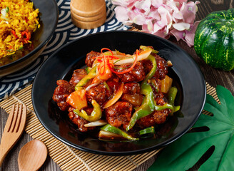 sweet and sour spare ribs with bell peppers and onion in plate side view of hong kong food