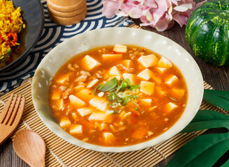 Sichuan Mapo Tofu with ground meat and green onions in bowl side view of hong kong food