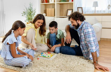 Family enjoys game night in cozy living room