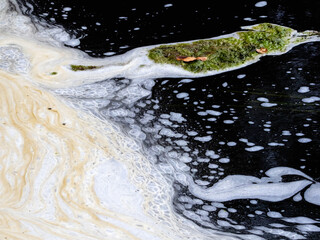 Extremely polluted water, with white foam.
