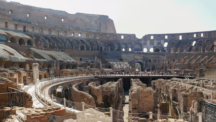 Looking up at the towering walls of the colosseum during the summer in Rome