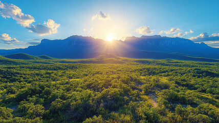 Obraz premium Lush Green Landscape and Majestic Mountains at Sunset
