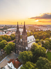 Vysehrad Basilica of St. Peter and St. Paul stands tall against a stunning sunrise in Prague.
