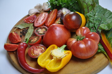 Close up of fresh vegetables and spices: tomatoes, garlic and chili pepper, paprika, tomato in...