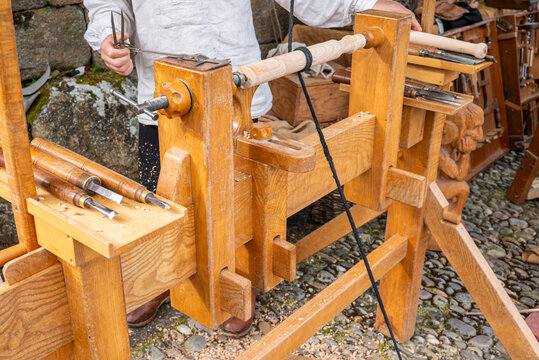 A craftsman working on a traditional woodturning lathe The Art of Skilled Labor