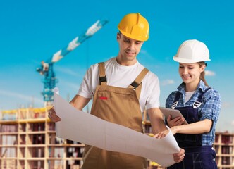 Two Architect discussing building plan at the construction site