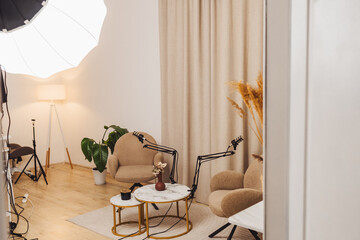 Cozy podcast studio setup with microphone and seating for engaging interviews in a modern space