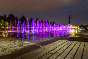 Long exposure night shot of dry fountain with purple illuminated water jets at Muzeon Park of Arts. Popular recreation spot in Moscow, Russia.