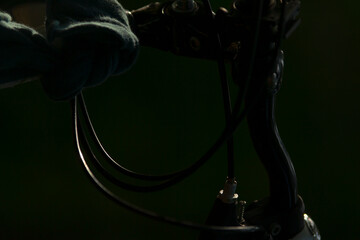 Artistic close-up shot showcasing bicycle handlebars and cables, highlighting intricate details in a moody atmosphere.