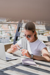 digital nomad woman working remotely from a cozy kitchen during breakfast. Remote work,...