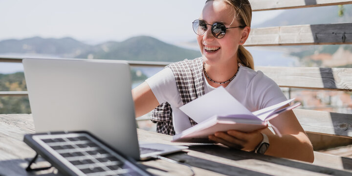 digital nomad woman working remotely from a cozy kitchen during breakfast. Remote work, sustainability, wellness, Gen Z, conscious living, home office and online freelancing