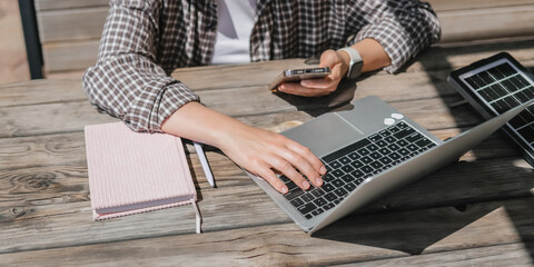 digital nomad woman working remotely from a cozy kitchen during breakfast. Remote work,...