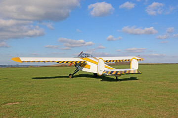 Light airplane standing on a grass runway	