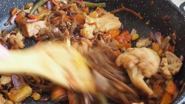 Schezwan Noodles or Vegetable Hakka Noodles or Chow Mein in white bowl. Schezwan Noodles is indo-chinese cuisine hot dish with udon noodles, vegetables and chilli sauce with meat, Japanese food