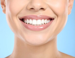 Obraz premium smiling woman with white teeth and a toothbrush in her mouth