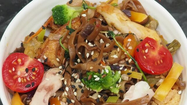Schezwan Noodles or Vegetable Hakka Noodles or Chow Mein in white bowl. Schezwan Noodles is indo chinese cuisine hot dish with udon noodles, vegetables and chilli sauce with meat, Japanese food