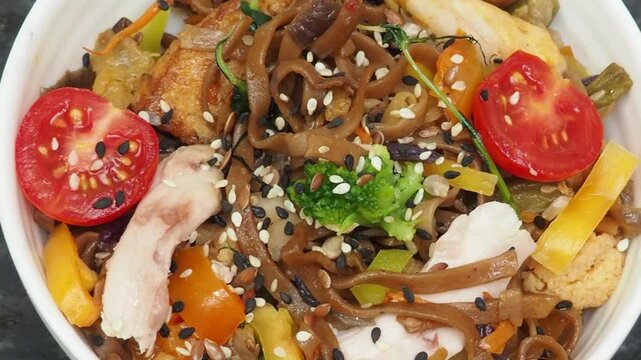 Schezwan Noodles or Vegetable Hakka Noodles or Chow Mein in white bowl. Schezwan Noodles is indo chinese cuisine hot dish with udon noodles, vegetables and chilli sauce with meat, Japanese food