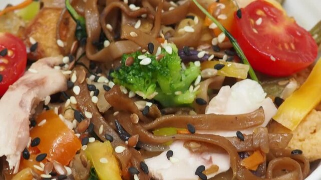 Schezwan Noodles or Vegetable Hakka Noodles or Chow Mein in white bowl. Schezwan Noodles is indo chinese cuisine hot dish with udon noodles, vegetables and chilli sauce with meat, Japanese food