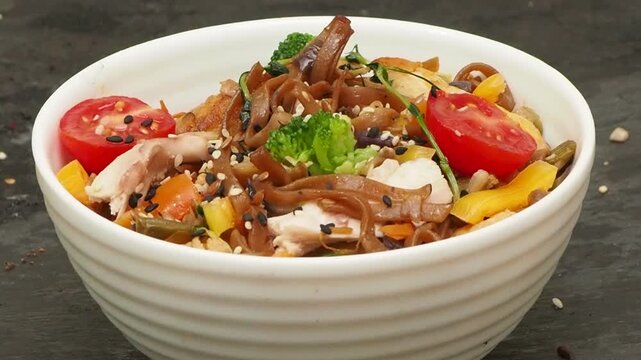 Schezwan Noodles or Vegetable Hakka Noodles or Chow Mein in white bowl. Schezwan Noodles is indo chinese cuisine hot dish with udon noodles, vegetables and chilli sauce with meat, Japanese food