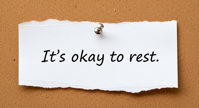 Gentle Reminder for Reflection: A simple note on a corkboard conveys the reassuring message of rest and self-care. It embodies the importance of mindfulness in the pursuit of wellness.