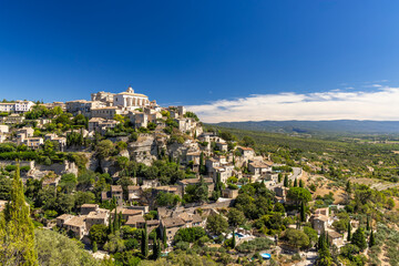 Obraz premium Gordes dominating the landscape in Provence, France, under a blue sky