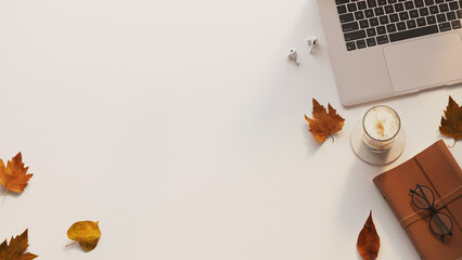 Laptop, coffee and autumn elements flat lay mockup on neutral background in warm daylight
