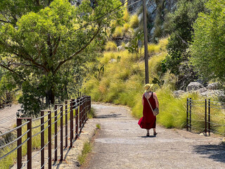 A woman hiker walks along the beautiful route leading up to Monte Pellegrino 