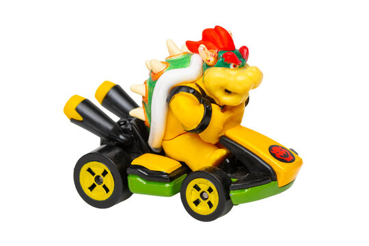 Supermario Bros character Bowser figurine driving a race kart on white background
