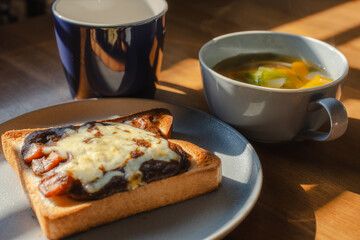 Breakfast with cheese toast, vegetable soup, and coffee
