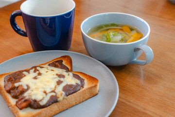 Breakfast with cheese toast, vegetable soup, and coffee
